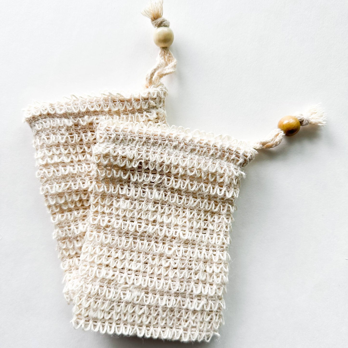 Natural sisal soap saver bag on natural background