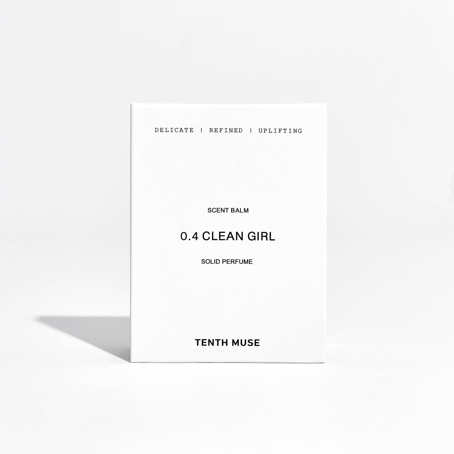 Close-up of Clean Girl solid perfume balm packaging with branding visible