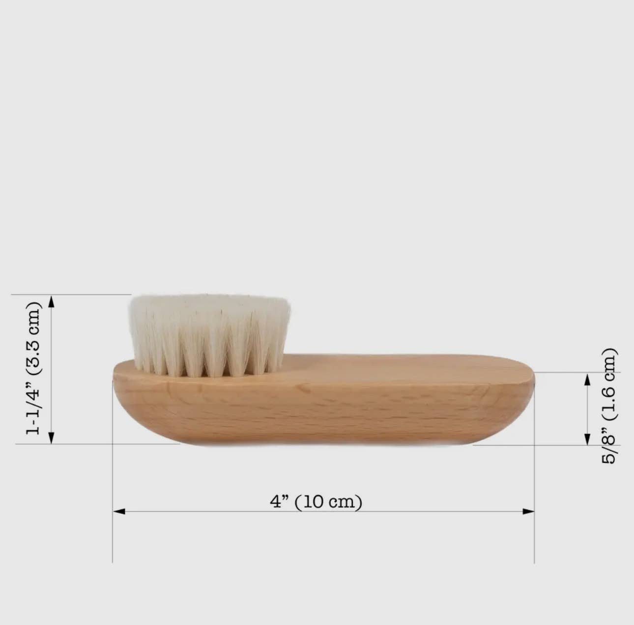 Natural face brush with dimensions marked, white backdrop
