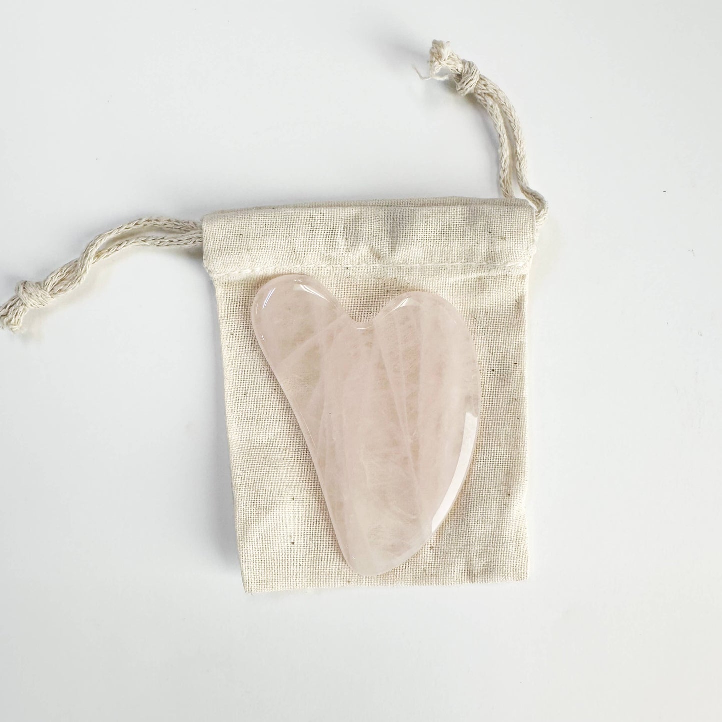 Natural Gua Sha stone on linen pouch