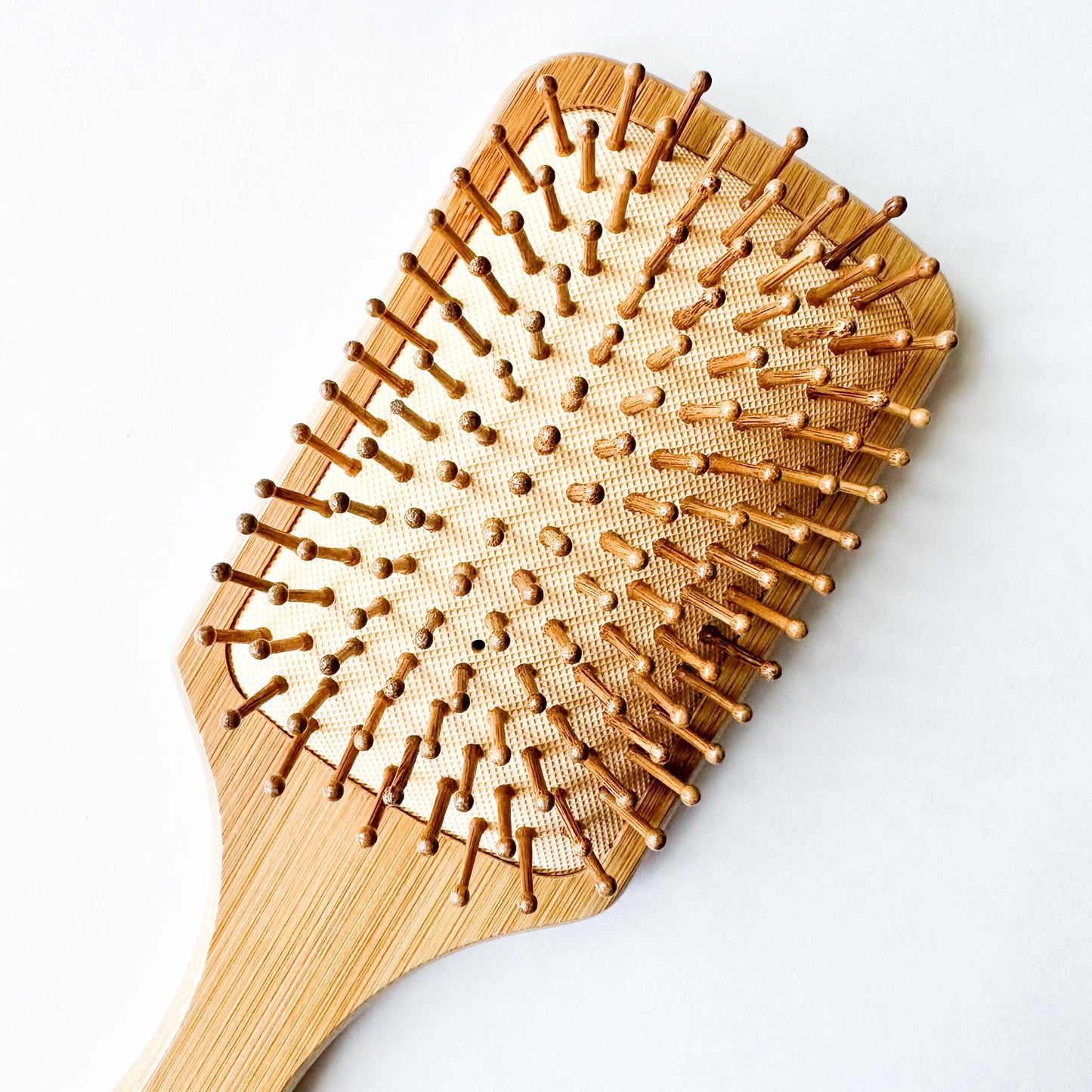 Natural bamboo hairbrush designed to reduce static and tame flyaways