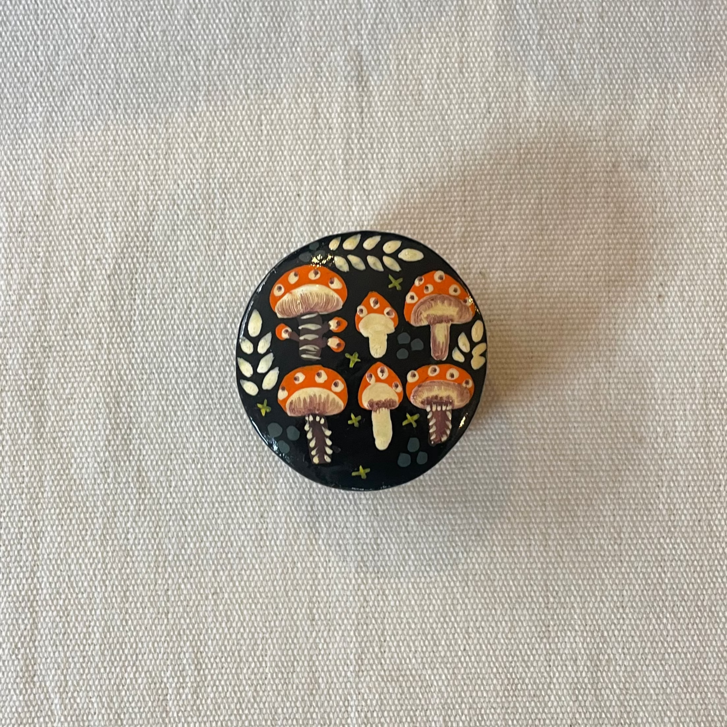 Kashmiri trinket box painted with red mushrooms, viewed from above