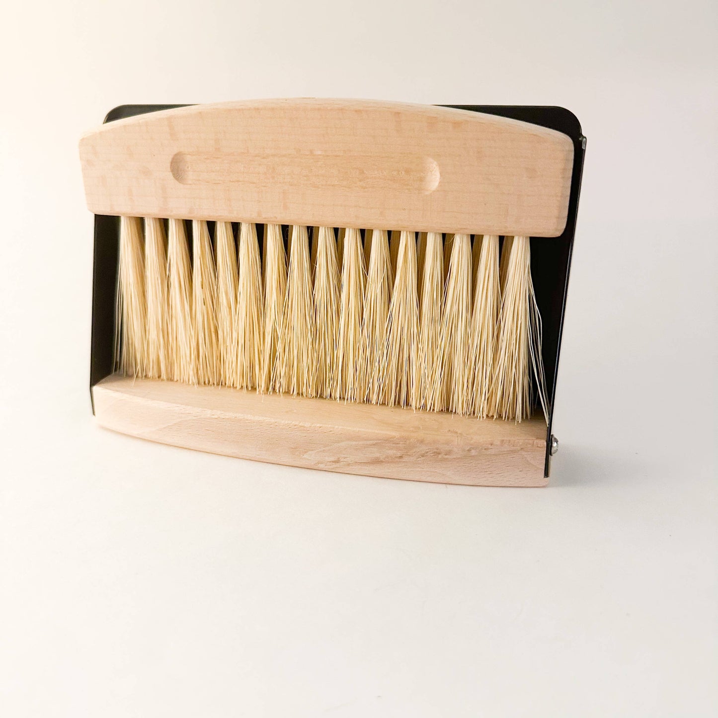 Eco-friendly compact dustpan & brush set in black finish clipped together magnetically