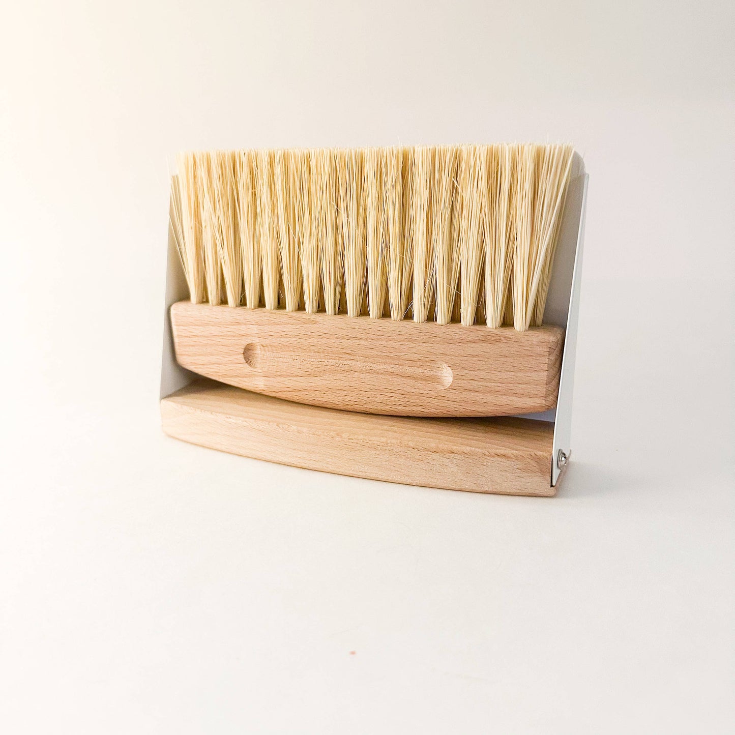 Eco-friendly compact dustpan & brush set in white finish clipped together magnetically