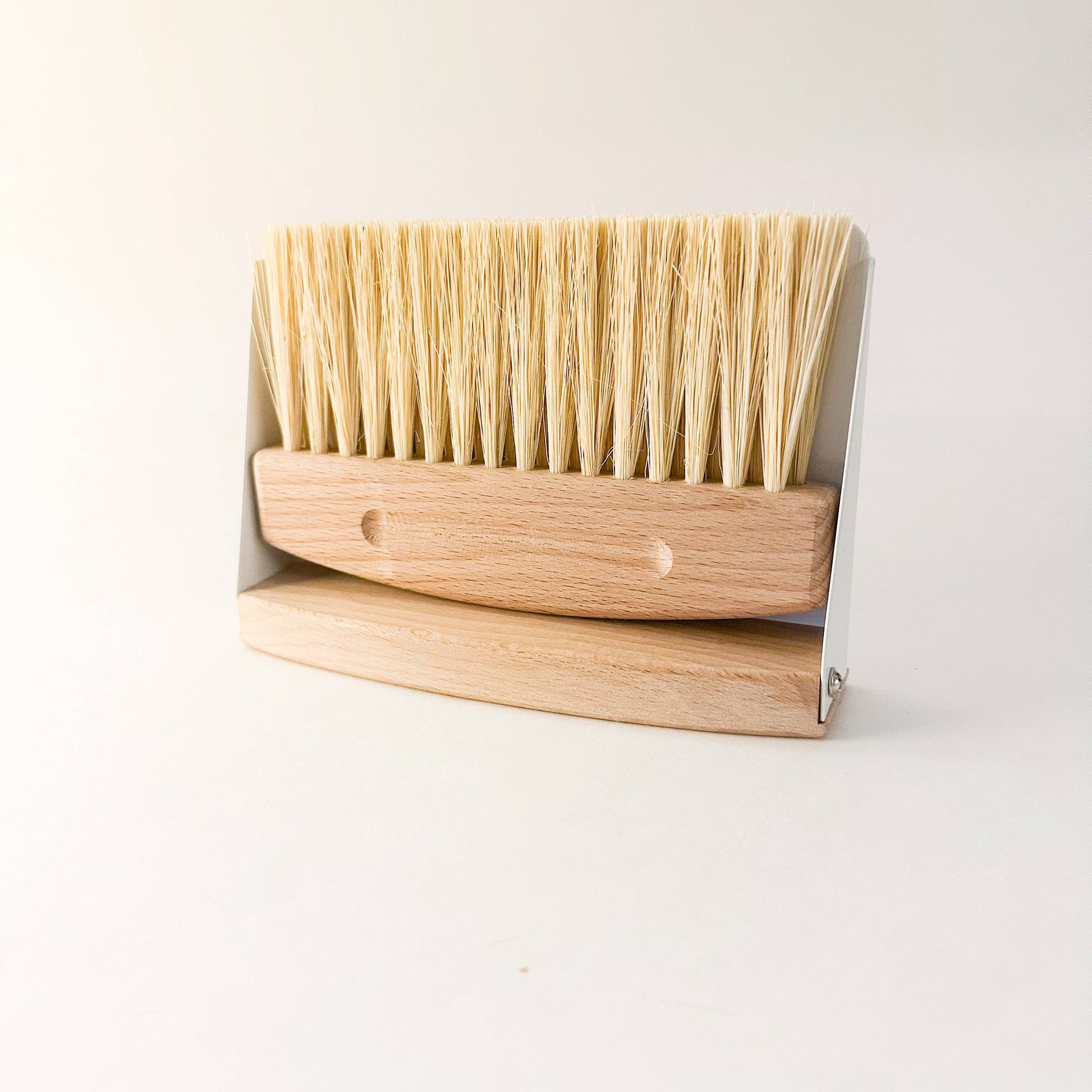 Eco-friendly compact dustpan & brush set in white finish clipped together magnetically